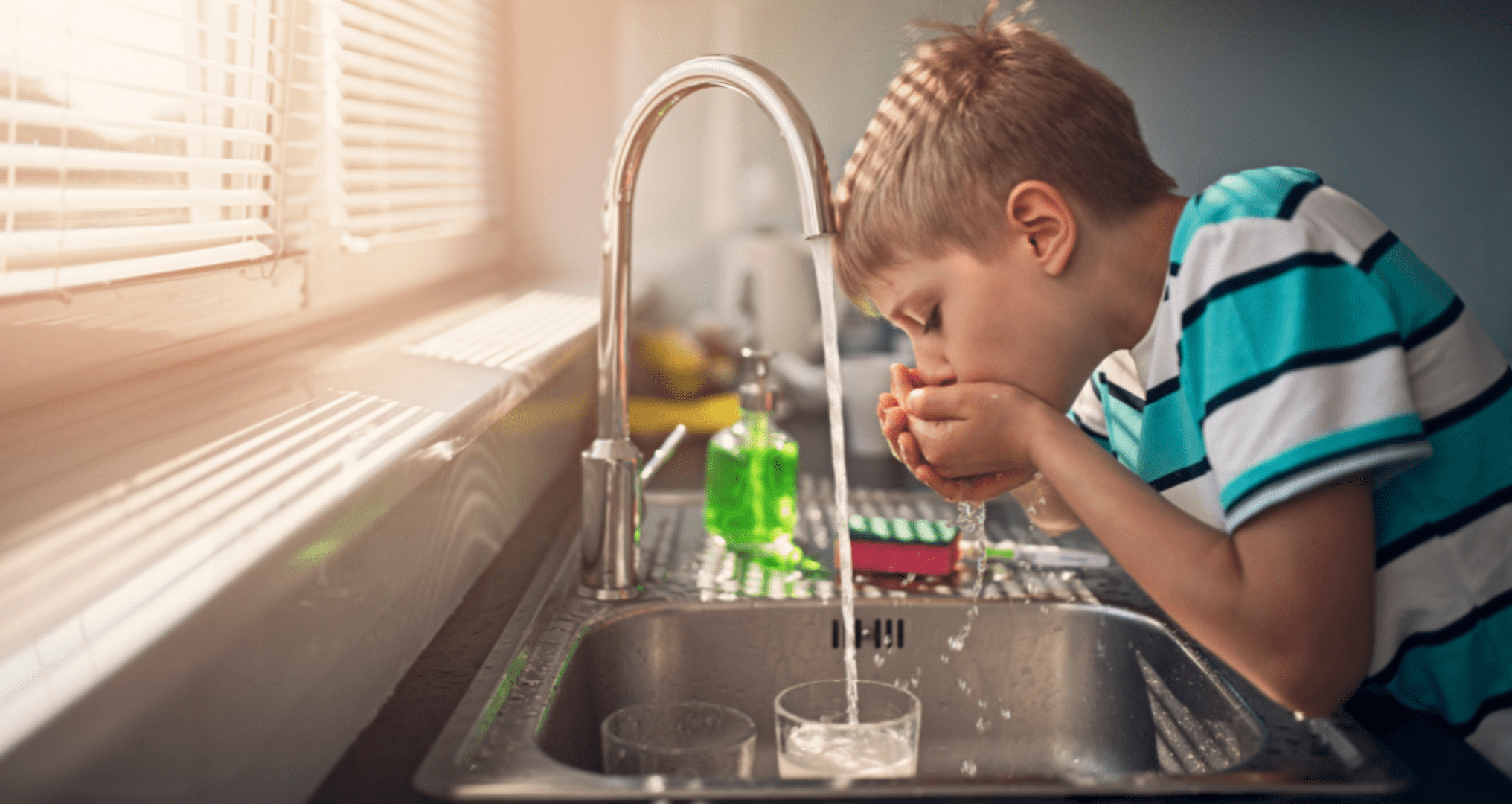 child drinks from unfiltered tap water