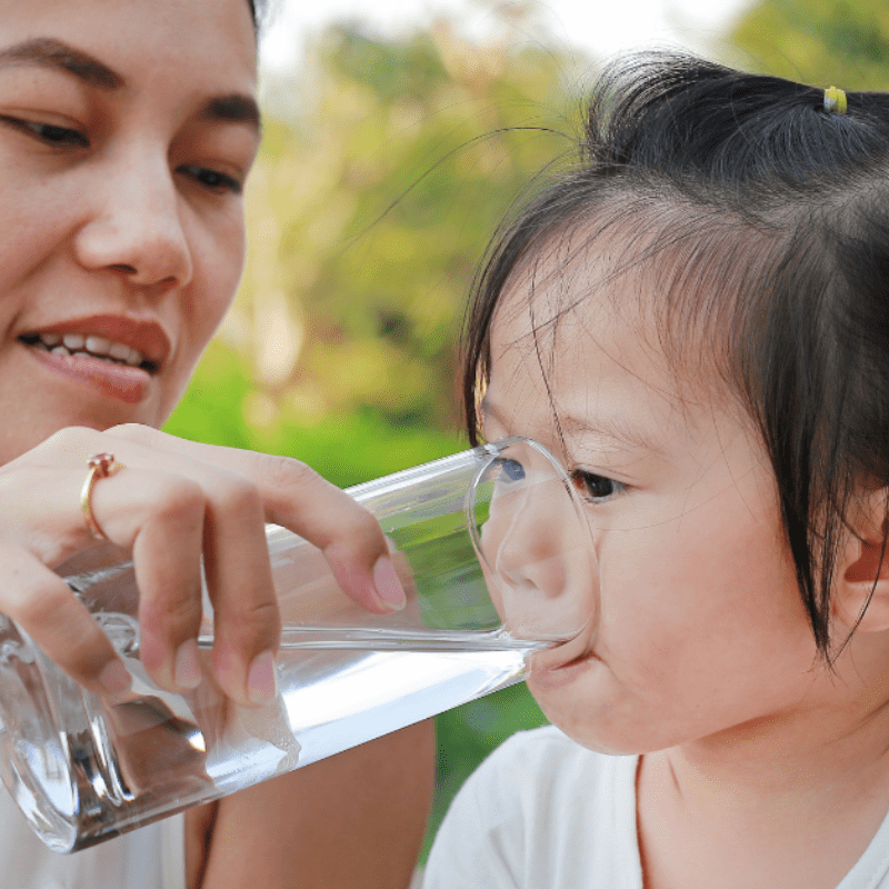 mom gives clean drinking water to daughter