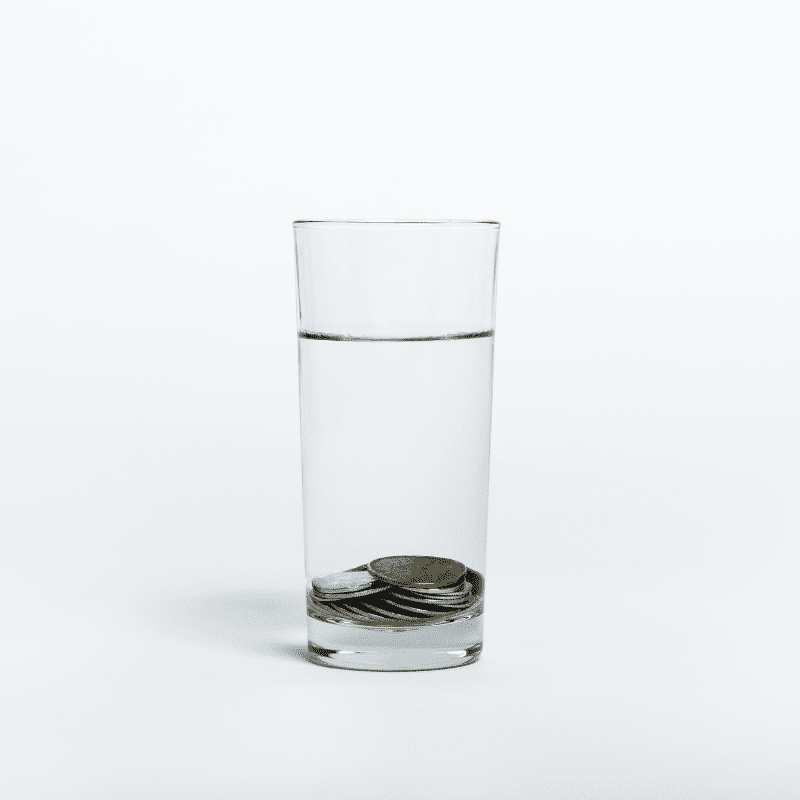 Coins inside a glass of water.
