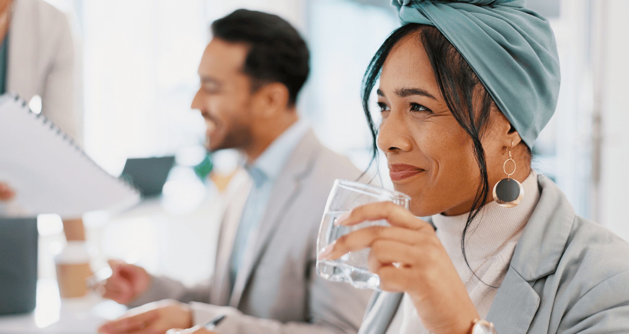 smiling woman drinking water at the office