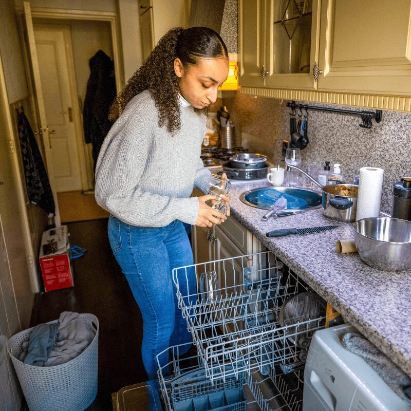 woman putting dishes in the dishwaser